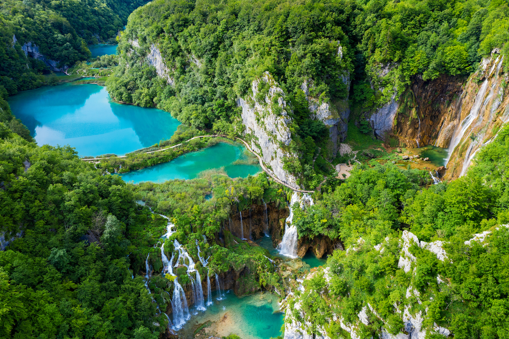 Discover Plitvice Lakes National Park in Croatia, a UNESCO World Heritage site famous for its stunning turquoise lakes, cascading waterfalls, and scenic hiking trails through lush forests