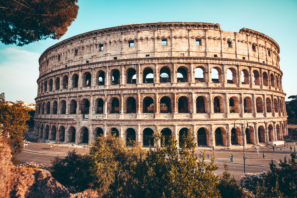Inside the Colosseum Arena Floor with ancient stone walls and arches in Rome, Italy