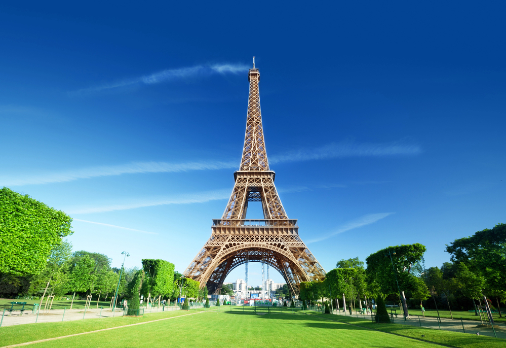 View looking up at the Eiffel Tower from the base with people climbing the stairs, Paris, France