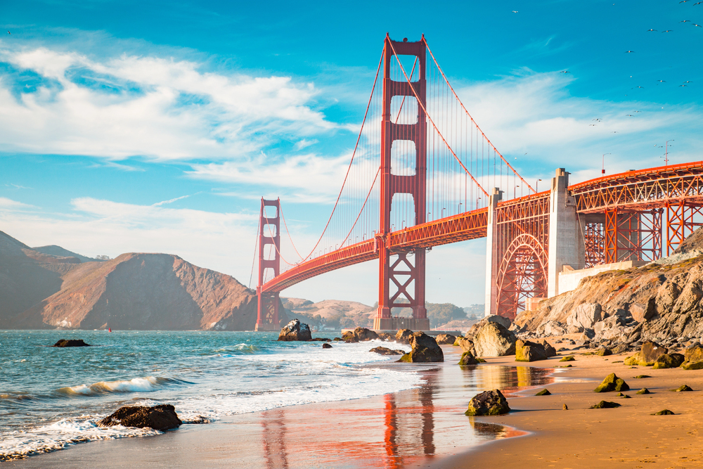 Boat cruising on San Francisco Bay with the Golden Gate Bridge in the background on a clear day, California, USA