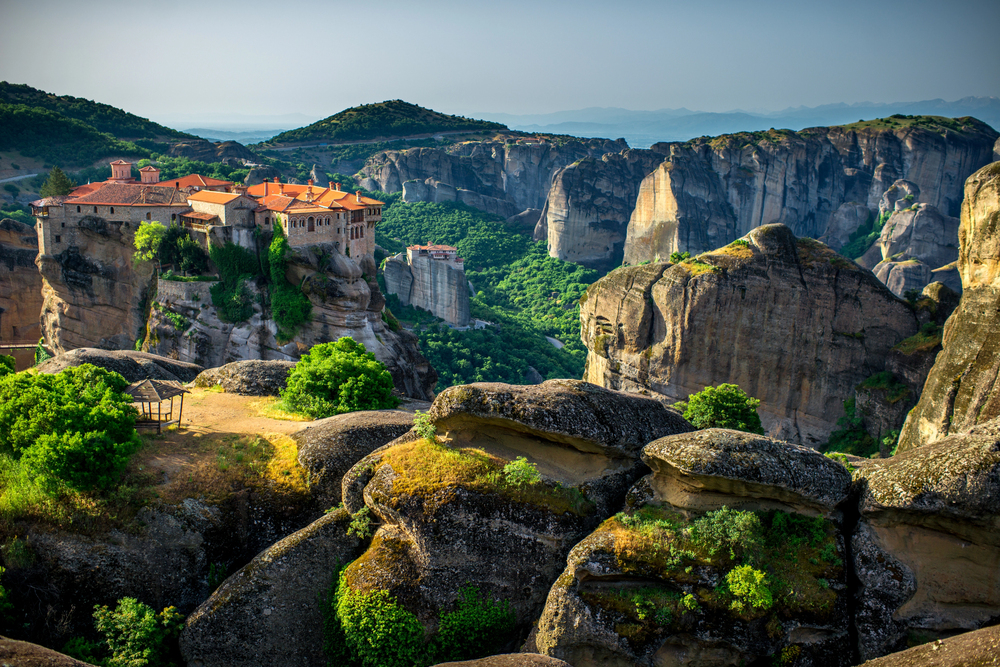 Ancient Meteora monasteries perched on towering cliffs above the valley in central Greece